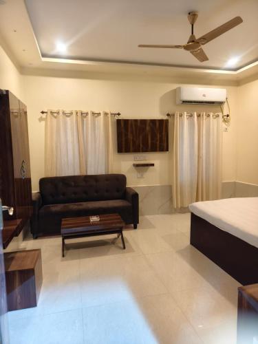 a living room with a couch and a table at Balaji Guest House in Jhārgrām