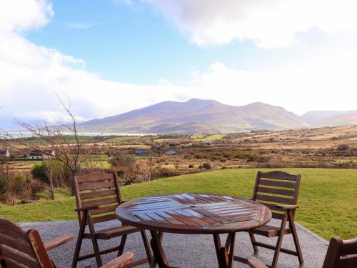 two chairs and a table with a view of mountains at Johnson's Cottage in Brandon