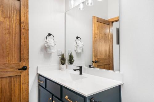 a bathroom with a sink and a mirror at New Log Cabin with Ozark Sunset Views, $400 Daily Activities Included, Pickleball in Branson