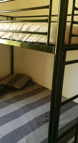 a room with a bunk bed and a ladder to a bunk bed at Villa santa karina in Linguizzetta