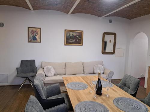 a living room with a table and a couch at Penzion U Cyrila in Moravská Třebová