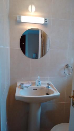 a bathroom with a sink and a mirror at Corrib View Guesthouse h91rr72 in Galway