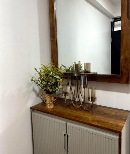 a mirror on top of a cabinet in a room at Nomentano Blue -Luxury Apartments- in Nuwara Eliya