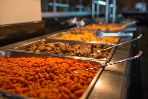 a buffet line with many trays of food at Astir Palace Hotel in Laganas
