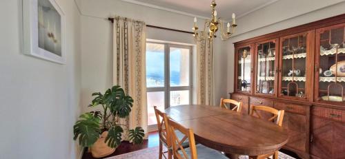 a dining room with a table and chairs and a window at SolMar View Apartment, Azores in Ponta Delgada