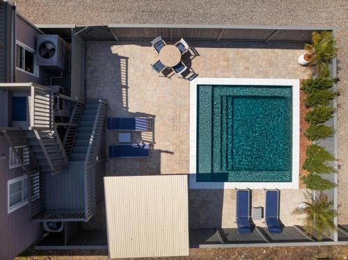 an overhead view of a swimming pool with blue chairs at Private HEATED Pool Oasis 4 Bedroom Suite in Charleston