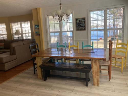 a wooden dining room table and chairs in a living room at House # 08 Dock of the Bay (no pets) private pier in Centre