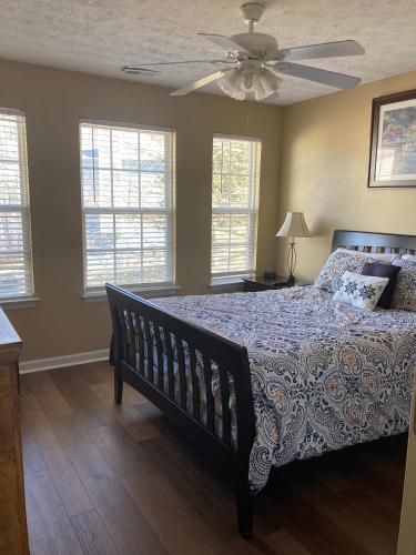 a bedroom with a bed and a ceiling fan at House # 08 Dock of the Bay (no pets) private pier in Centre