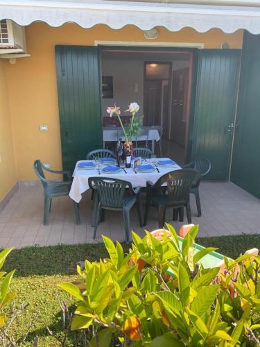 a table and chairs sitting on a patio at RESORT VILLAGE AQUA MARINA FAMILY - Daily Rooms Tidying - CocktailsBar- Pet Friendly - with Hypermarket - Delivery Restaurant-Pizzeria - Room Breakfast with supplement - Ultra Fast Wi-Fi - Play Area for children - Olympic Swimming Pool - Parking in Caorle