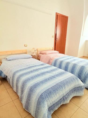 Ένα ή περισσότερα κρεβάτια σε δωμάτιο στο CASALUNA - Dimora Vacanze