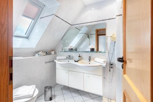 a bathroom with a sink and a toilet at Villa Sunside Appartements in Schluchsee