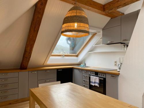 a kitchen with a large window and a wooden table at Hotel Pension Seehaus in Bodman-Ludwigshafen