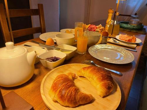 a table with a plate of croissants on it at La Maison Joly in Ménerbes