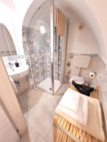 a bathroom with a shower and a toilet and a sink at Il Vicolo b&b in Putignano