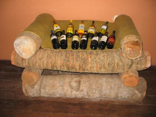 a couch with a bunch of wine bottles on it at Maningory in Ile aux Nattes