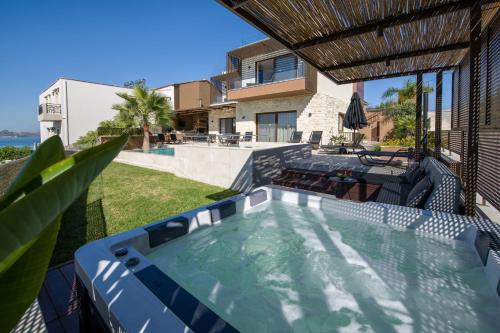an image of a house with a swimming pool at Almi-Cove Hilltop Villas in Almirida