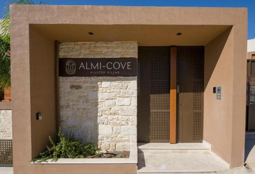 a sign for the almighty cove building at Almi-Cove Hilltop Villas in Almirida