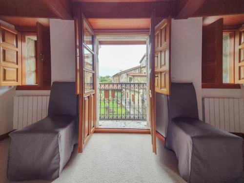 a room with two chairs and a large window at La Casita del Montañes in Liérganes