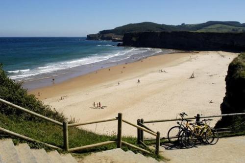 a beach with a bunch of people on it at La Casita del Montañes in Liérganes