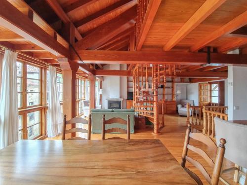 a dining room with a large wooden table and chairs at La Casita del Montañes in Liérganes