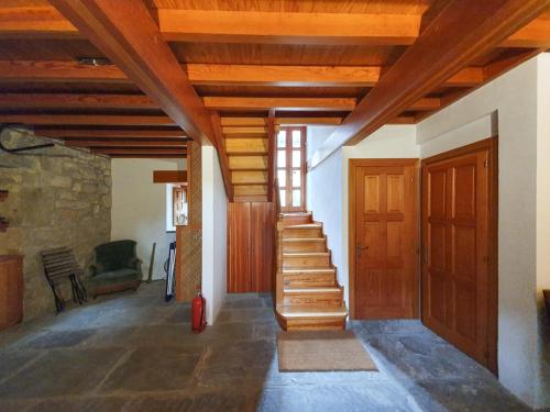 a hallway with wooden ceilings and stairs in a house at La Casita del Montañes in Liérganes