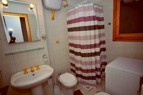 a bathroom with a sink and a toilet and a shower at Residence La Bricola LB 238 in I Casoni