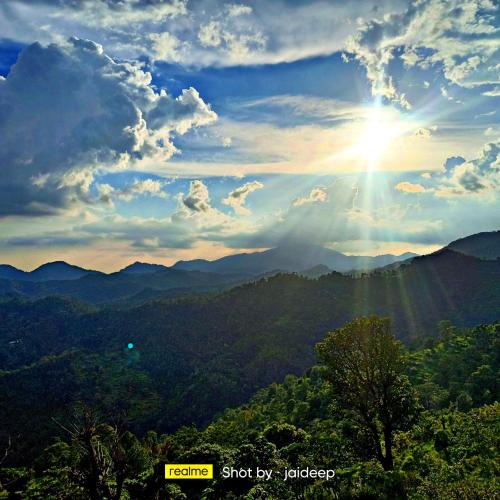 a view of the mountains with the sun in the sky at Rameshwari Homestay in Lansdowne