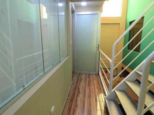 a hallway with a door and stairs in a room at Mamre Guest House Tacna - Hospedaje in Tacna