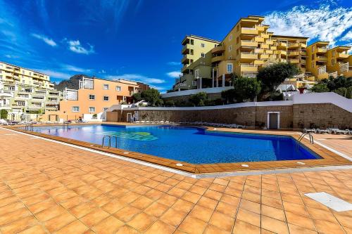 a swimming pool in the middle of a building at Costa Adeje - Orlando apartments in Adeje