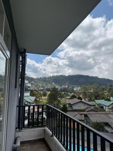 a balcony with a view of a city at Nomentano Blue -Luxury Apartments- in Nuwara Eliya