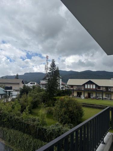 a view from a balcony of a town with houses at Nomentano Blue -Luxury Apartments- in Nuwara Eliya