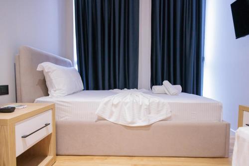 two white beds in a room with a window at Bel Ami Tirana 2 in Tirana