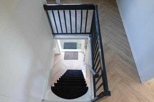 an overhead view of a staircase with a black carpet at Ithaka Beach House, unieke plek met vrij parkeren! in Noordwijk