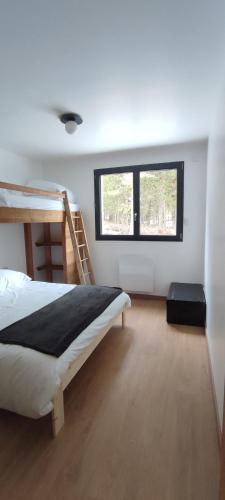 une chambre avec un lit superposé et deux fenêtres dans l'établissement Appartement au cœur de la forêt au calme et proche des pistes et des commodités, à Bolquère-Pyrénées 2000