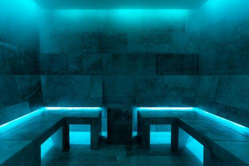a room with two benches and blue lights at Home's am Hof in Nauders