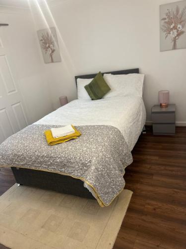 a bedroom with a bed with a blanket on it at House of Nico Corby in Rockingham