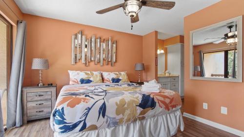 a bedroom with a bed and a ceiling fan at 5 minutes walk to beach, Family Friendly condo with shared pool, tennis court in Panama City Beach