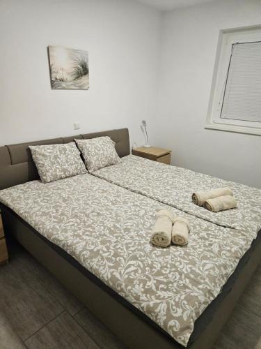 a bedroom with a bed with two shoes on it at Apartma Zala in Brežice