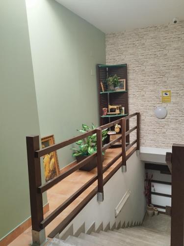 a staircase with wooden railings in a room at Albergue Kortarixar in Elizondo