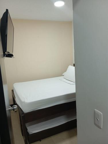 a small bedroom with a bed in a room at Hermoso Apartasol!! cerca a Plaza Principal, Aire Acondicionado, Vista a la Piscina in Santa Fe de Antioquia