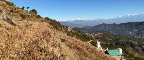 a view of a hill with a church on it at Satyam Shivam Sundaram in Mukteswar