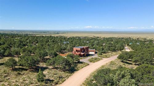 an aerial view of a house on a dirt road at Crestone Adobe Vista Manor in Crestone