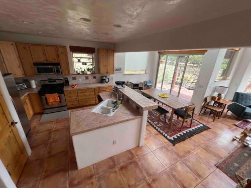an aerial view of a kitchen with a sink and a table at Crestone Adobe Vista Manor in Crestone