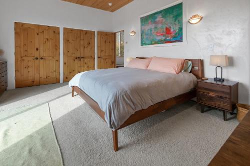 a bedroom with a large bed and wooden cabinets at Crestone Adobe Vista Manor in Crestone