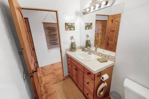 a bathroom with a sink and a mirror at Crestone Adobe Vista Manor in Crestone