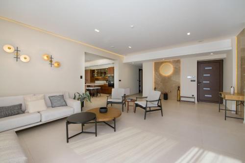 a living room with a couch and chairs and a table at Almi-Cove Hilltop Villas in Almirida