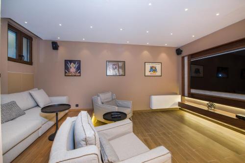 a living room with white furniture and a large window at Almi-Cove Hilltop Villas in Almirida
