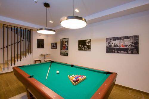 a pool table in a living room with afits at Almi-Cove Hilltop Villas in Almirida