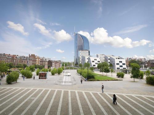 a large plaza in a city with a tall building at Miracle Luxury Property Liège Guillemins in Liège