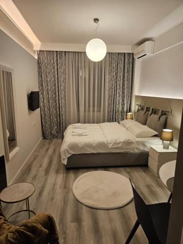 a bedroom with a bed and a table and chairs at TRISAP Luxury Suites T Suite in Thessaloniki